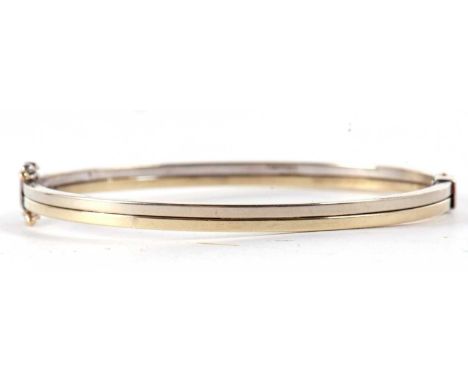 A 9ct hinged bangle, the two tone bangle stamped 375 and hallmarked London 2006, also stamped 9k to hinge, inner diameter 6cm
