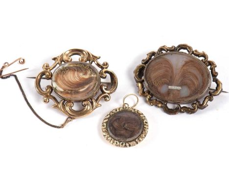 Two late Victorian hairwork memorial brooches and a pendant, to include an oval hairwork and seed pearl brooch with unmarked 