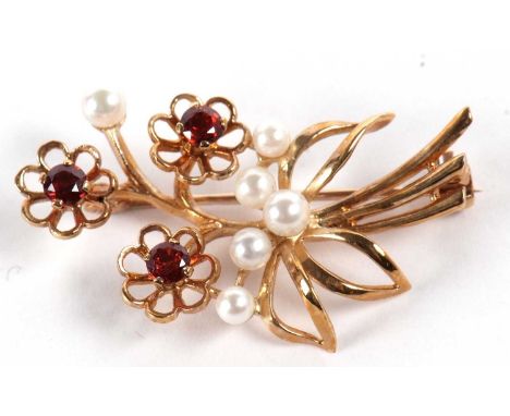 A 9ct cultured pearl and gemset floral spray brooch, the three flowerheads set with deep pinky-orange gemstones and set with 