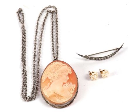 An oval shell cameo mounted in white metal (marks worn) on white metal chain, together with a crescent moon paste brooch and 