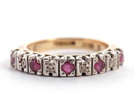 A 9ct ruby and diamond half eternity ring, the alternating round rubies and illusion set diamonds, all set in white gold to a