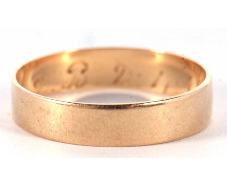 A yellow metal wedding ring of plain polished design engraved inside with a D.B 2.4.18, tests 9ct gold, 2.2 gms, size S/T