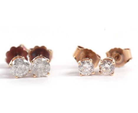 Two pairs of diamond earstuds, the first approx. 0.40cts each, claw mounted with posts and screw fitting butteflies stamped 5