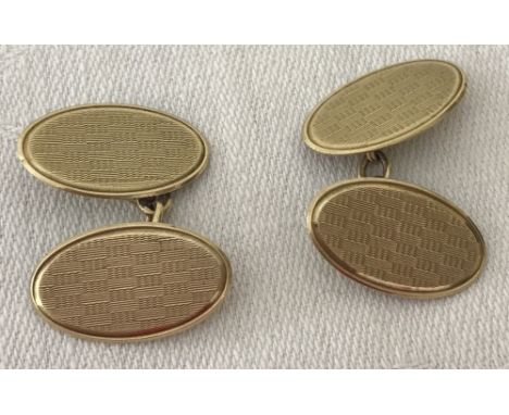 A pair of 9ct gold oval cufflinks with engine turned decoration. HM Chester 1926. Weight approx 4.9g.
