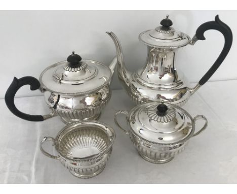 A hallmarked silver Queen Anne style 4 piece tea set with fluted design and pedestal shaped base. Comprising Coffee pot (appr