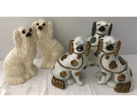 A collection of Staffordshire ceramic fire dogs to include a pair of lustre spaniels. Together with a rarer green spaniel. La