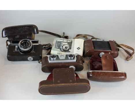 A Wray London Stereo Graphic camera, an Agfa Isolette camera and a Minolta camera