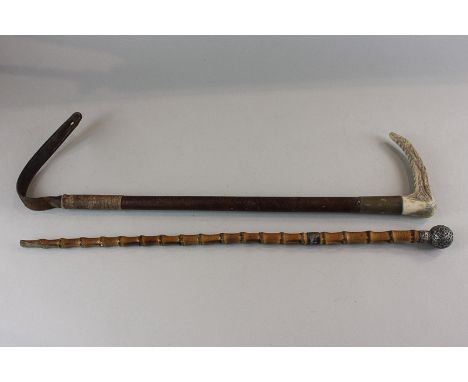 An antler handled leather riding crop and a Victorian silver mounted bamboo 'swagger' stick