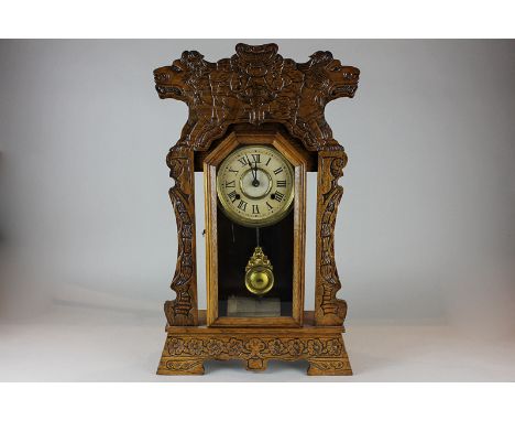 An American mantel clock in carved case with eight-day striking movement, 63cm high