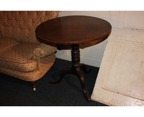 A George III country made oak tea table with circular tilting top on turned column and tripod base, 75cm