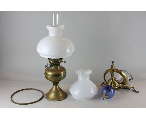 A brass oil table lamp and a hanging ceiling light