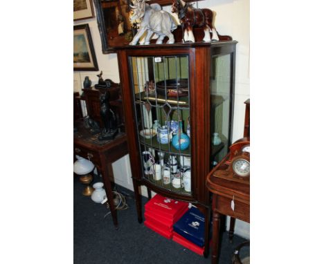 A small mahogany display cabinet with two shelves enclosed by one bow front leaded light door, 66cm wide by 150cm high