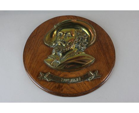 A brass portrait wall plaque of the artist Rubens, on circular wooden mount, 32cm