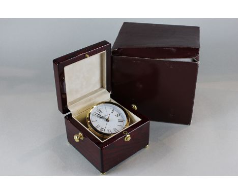 A Howard Miller quartz travelling clock with Roman numerals in 'chronograph' style case