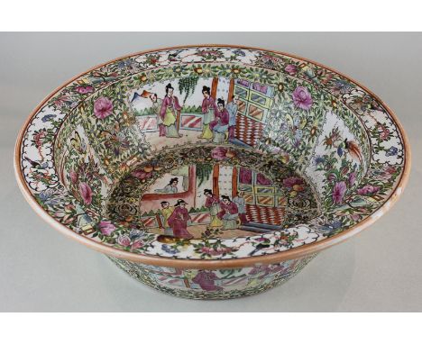 A 20th century 'Cantonese' pattern porcelain bowl decorated in bright enamel colours with figure and floral panels, 41cm diam