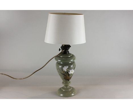 A green opaque glass oil lamp, baluster shape, decorated with flowers, now converted, height 35cm