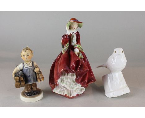 A Royal Doulton ornament Top of the Hill HN1834, designed by Leslie Harradine, 18cm high, together with a German boy ornament