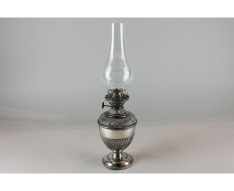 A plated oil table lamp with whorled reeded decoration on stemmed base
