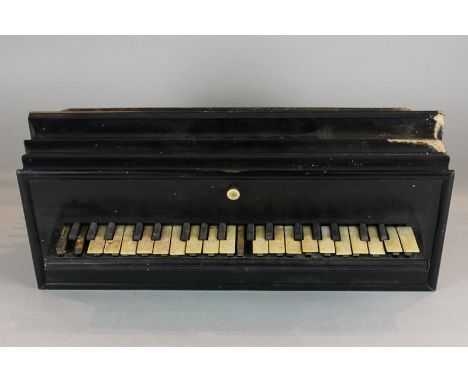 An ebonized cased piano accordion