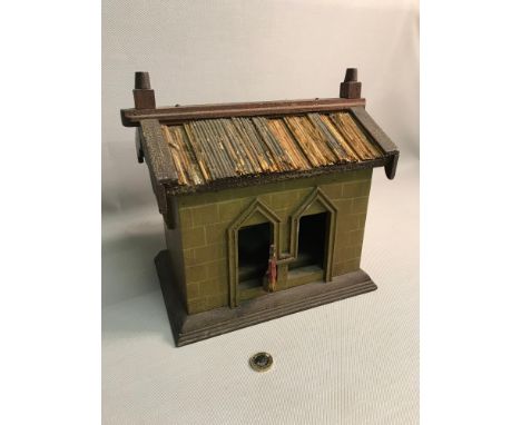 Antique wooden house done in the style of a cuckoo clock with two moving figures. 