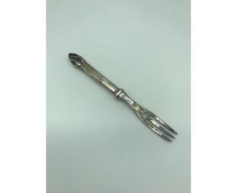 A Solid silver pickle fork, Styled in an arts and crafts manner with hammered handle and stone encased to the top,  London ma