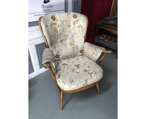 An elm wood spindle back ercol wing back chair with floral material upholstery. (cushions are removable) 