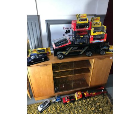 A quantity of boxed car models together with Tonka car transporter and fire engine 