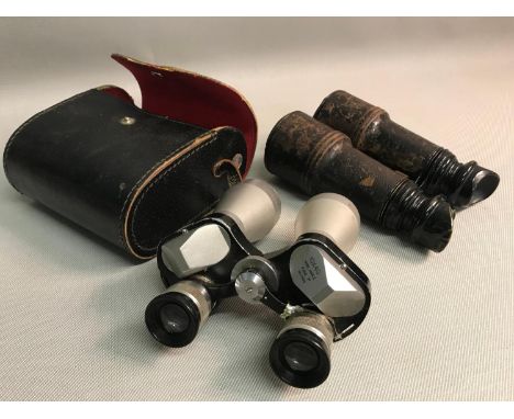 A Pair of 10x40 field binoculars with carry case together with Army &amp; Navy leather bound field binoculars 