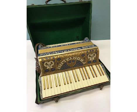 Frontalini Piano Accordion 120 base, designed in a flamboyant blue mother of pearl design, Circa 1920-1930, complete with ori