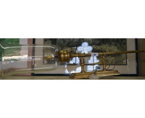 A modern brass table lamp in the form of a teardrop branch in glass shade. 