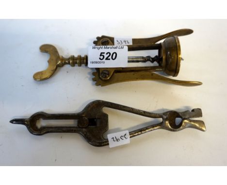 A Vintage brass metal corkscrew, together with a further base metal implement (2).