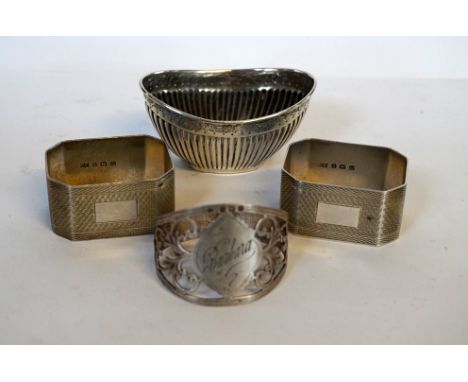 A pair of Birmingham hallmarked silver engine turned napkin rings together with a further hallmarked silver open salt and a f