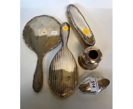 A mixed group of hallmarked silver items to include a hand mirror, clothes brush, hairbrush, dressing table pot and inkwell.