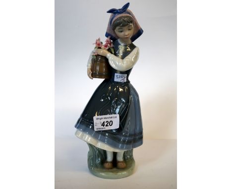 A Lladro figure of a girl holding flowers.