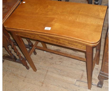 An early 20th Century mahogany breakfront fold-over card table, having tapering block supports.