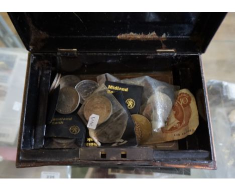 A vintage cash tin, containing a quantity of assorted coinage and banknotes.