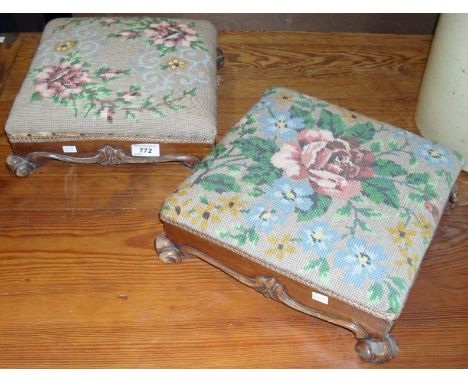 A pair of carved early 20th Century footstools, having tapestry inset tops.