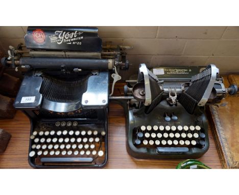 A vintage yost light running number 20 typewriter together with a Oliver typewriter.
