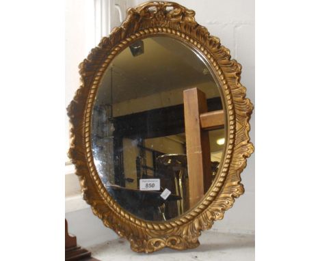 A mid 20th Century gilt framed wall mirror.