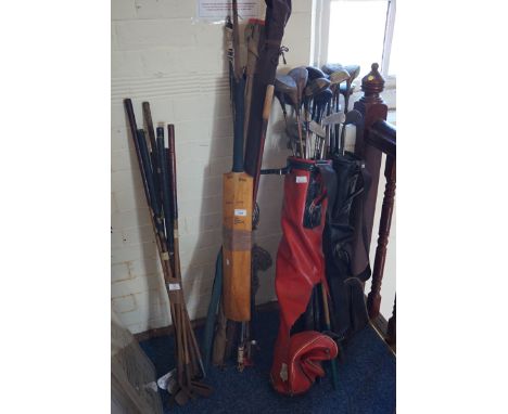 A quantity of assorted golf clubs together with a vintage cricket bat, etc.