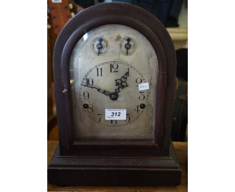 An early 20th Century mahogany arch topped chiming mantel clock.