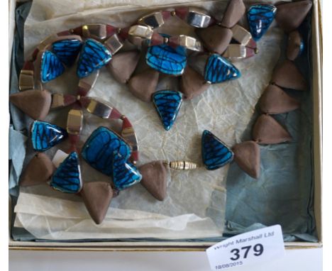 Alice Lund of Denmark, stylish blue enamel necklace with matching earrings, having geometric style design on a turquoise grou