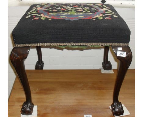 A 20th Century dressing table stool, having tapestry inset cushion, raised on ball and claw supports.