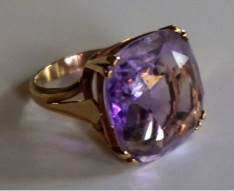 An Art Deco style 9ct gold dress ring with amethyst coloured stone, total weight 9.6gms.