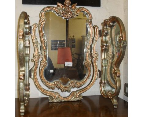 A reproduction Marie Antoinette style tryptic wall mirror.  