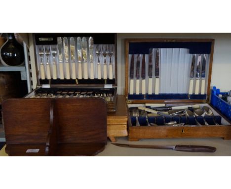 Three assorted oak cased canteens of silver-plated cutlery together with a oak shelf. 