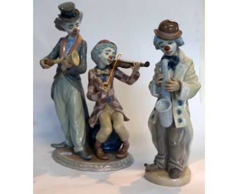 Two Lladro figurines of clowns one playing the saxophone and the other figure group playing the violin and hall trumpet (2). 