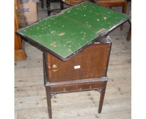 An unusual Rhind & Sons of Manchester mahogany games table/smokers cabinet, the hinged cover lifts to enclose a folding card 