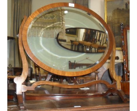 A large Edwardian mahogany oval framed bevelled edged dressing table mirror.