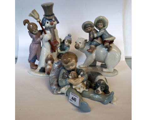 Three Lladro figures to include a boy and a girl sitting on a polar bear, a boy hugging three puppies and a dog, and a Lladro